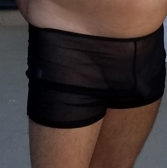 Black ultra sheer swim men's shorts displayed on a mannequin, showcasing the sheer material and stylish design.