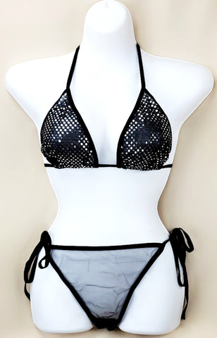 Black sheer embellished bikini set on a mannequin, featuring a triangle top with sparkly embellishments and tie-side bottoms.