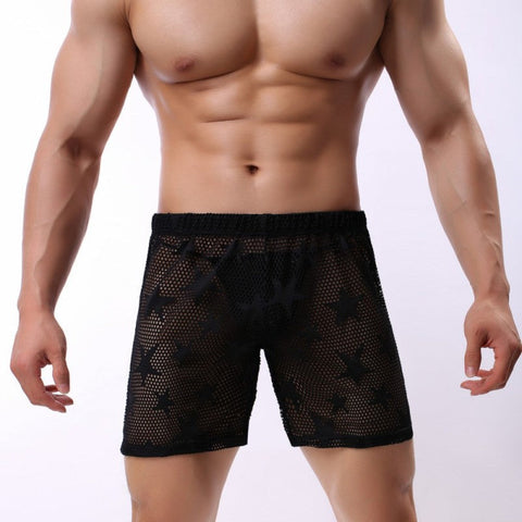  Black and white star sheer swim fishnet men's shorts displayed on a mannequin, showcasing the sheer material and star pattern.