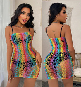 The image features a vibrant, multicolored dress made from a sheer, fishnet-like material. The dress showcases a rainbow pattern with horizontal stripes, creating a playful and eye-catching look. It has a fitted silhouette that accentuates the figure, with thin spaghetti straps for support. The design is both bold and sexy, making it suitable for parties, festivals, or beach outings. The sheer fabric adds an element of allure, allowing for layering over swimwear or other outfits.