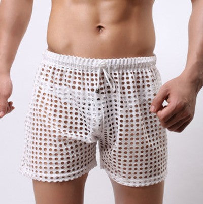 Sheer fishnet mesh trunks displayed on a mannequin, designed for unisex wear, showcasing the sheer material and stretchy waistband.